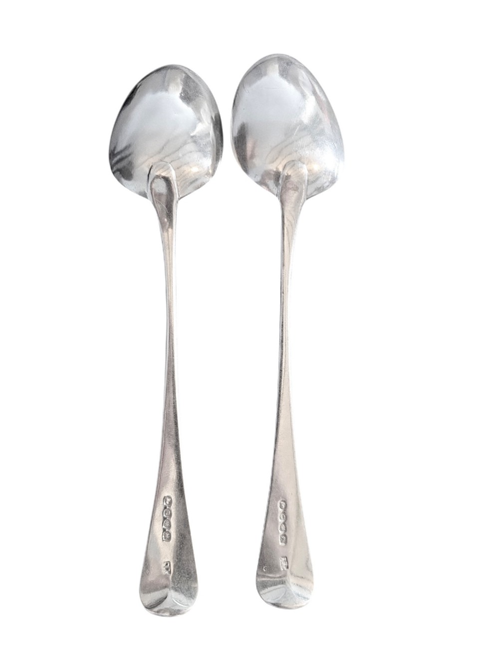 A pair of 1789 Georgian sterling silver serving spoons with oval bowls, long stems, and hand-engraved terminals. View II