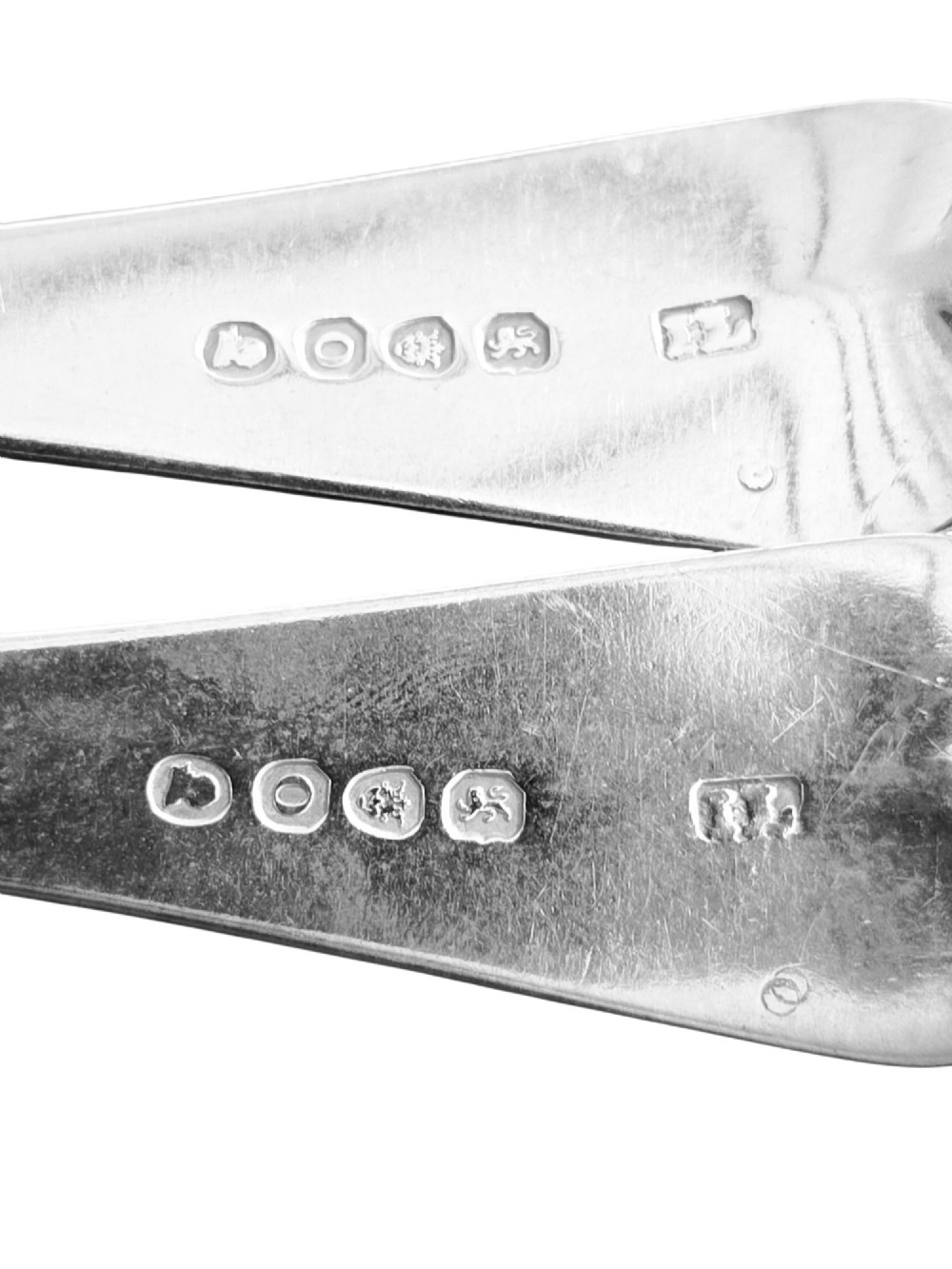 A pair of 1789 Georgian sterling silver serving spoons with oval bowls, long stems, and hand-engraved terminals. View III