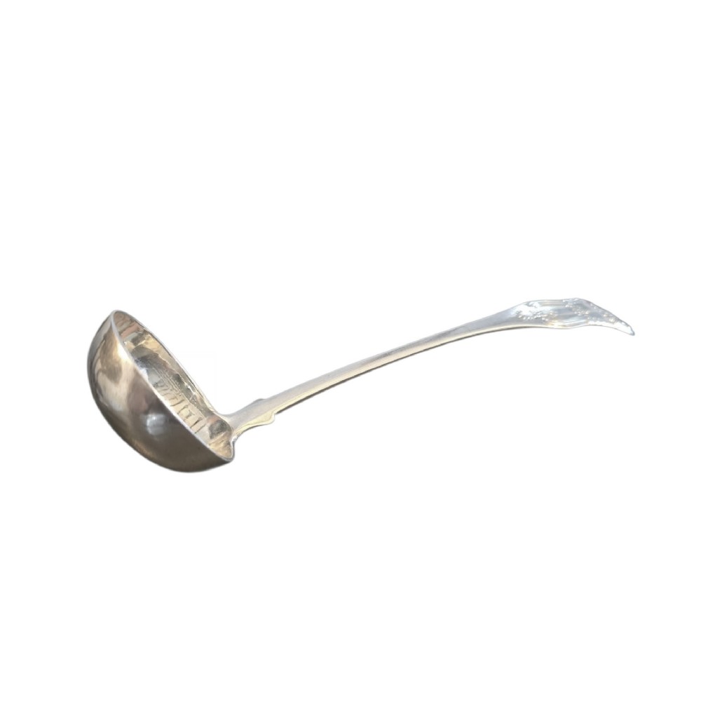 A Scottish sterling silver sauce ladle in Kings pattern, assay marked for Edinburgh in 1831, featuring a round bowl and ornate shell handle detailing. View III