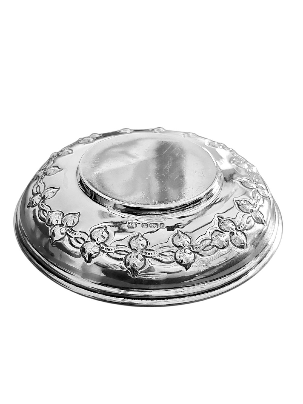 A small circular Edwardian sterling silver dish featuring a polished central well and a decorative pierced rim with geometric cut-outs. View III