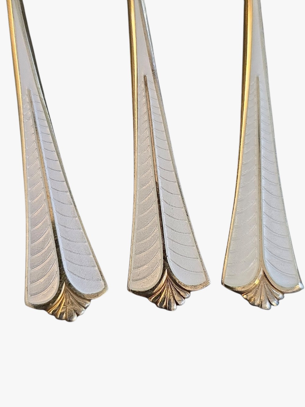 Set of six sterling silver gilt coffee spoons featuring white guilloche enamel flared handles. View V