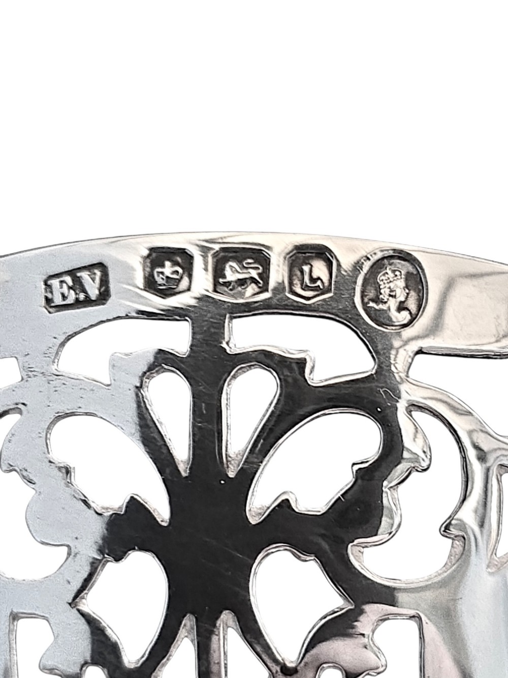 A hallmarked sterling silver bonbon dish featuring a pierced scalloped rim and a short pedestal foot. View V