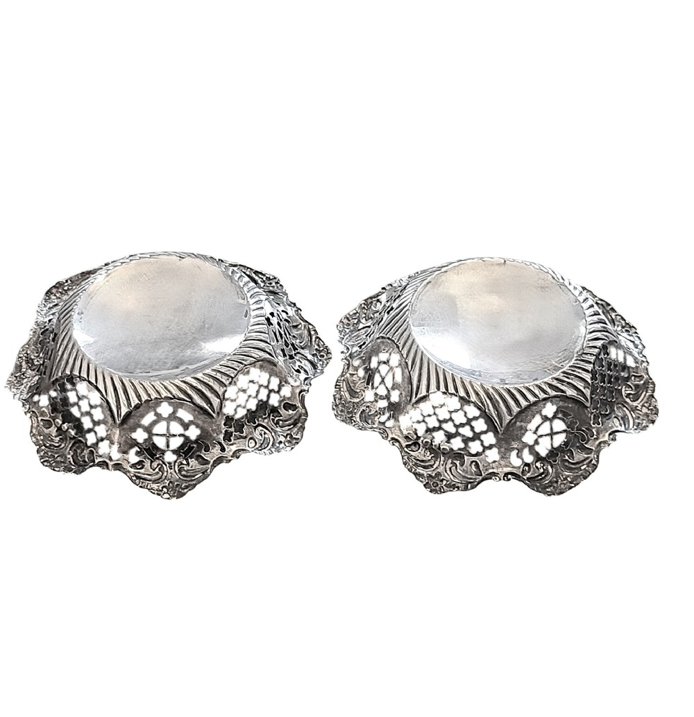 A pair of late Victorian sterling silver bonbon dishes with pierced lattice rims and scrolled edges. View II