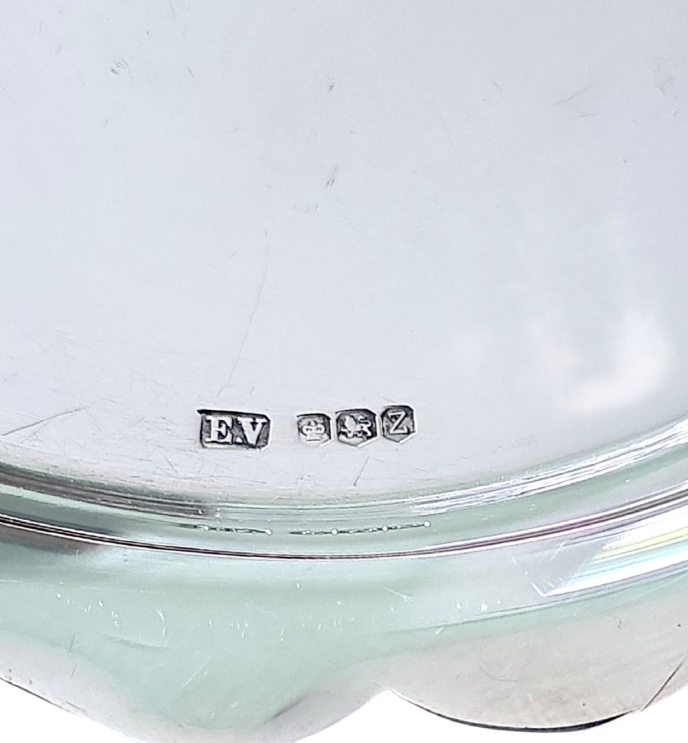 A small sterling silver card tray featuring a scalloped border and stamped British hallmarks on the flat surface. View III