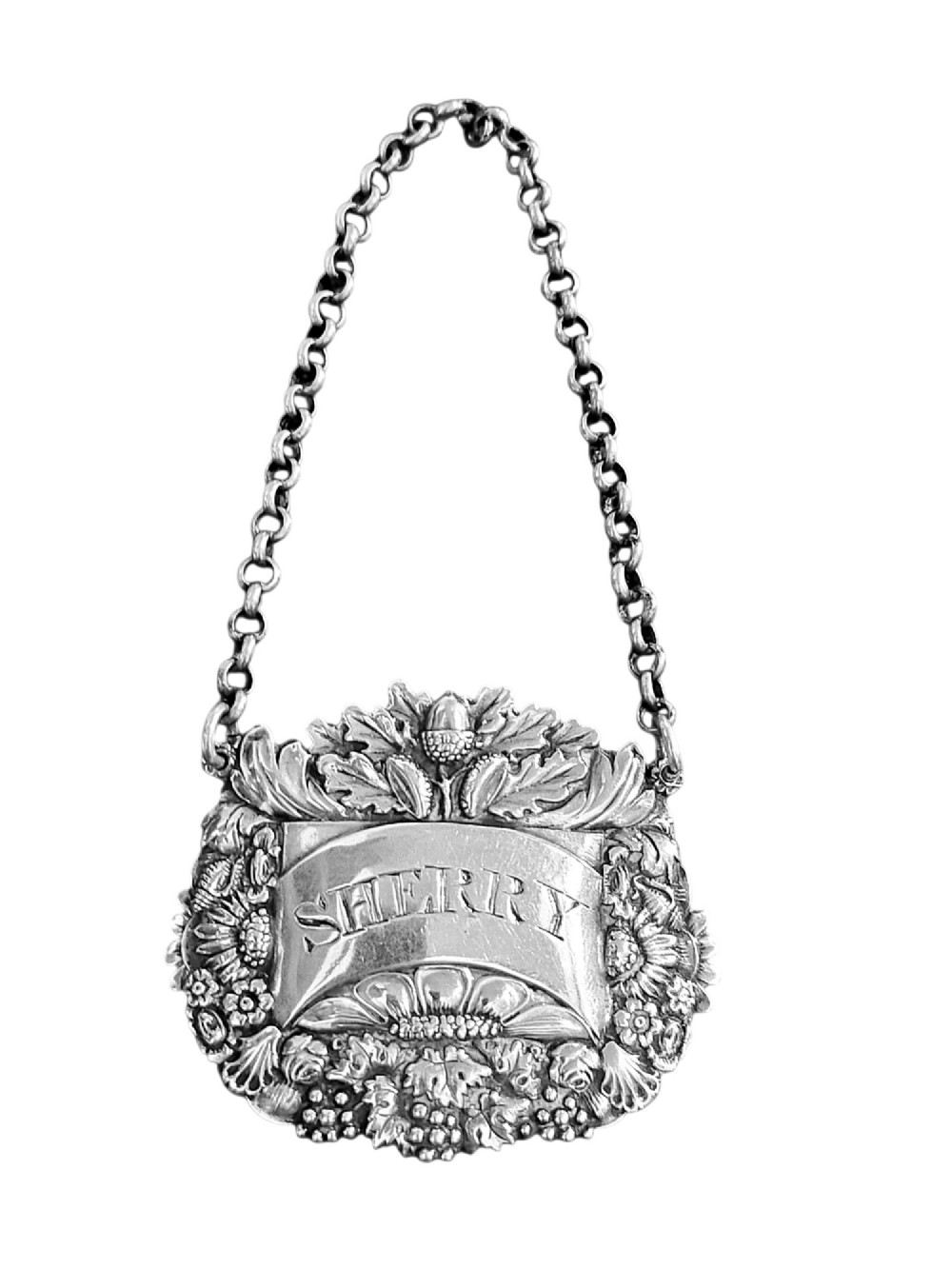 A Georgian sterling silver sherry decanter label featuring ornate floral and acorn repousse borders, an engraved central banner, and a chain suspension. View II
