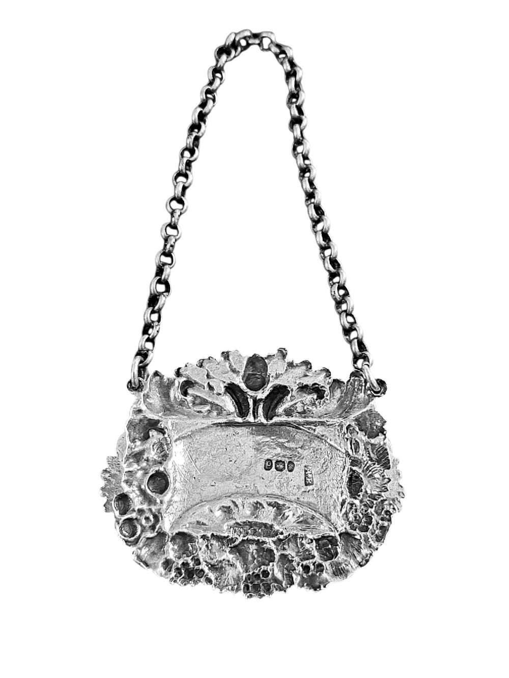 A Georgian sterling silver sherry decanter label featuring ornate floral and acorn repousse borders, an engraved central banner, and a chain suspension. View IV