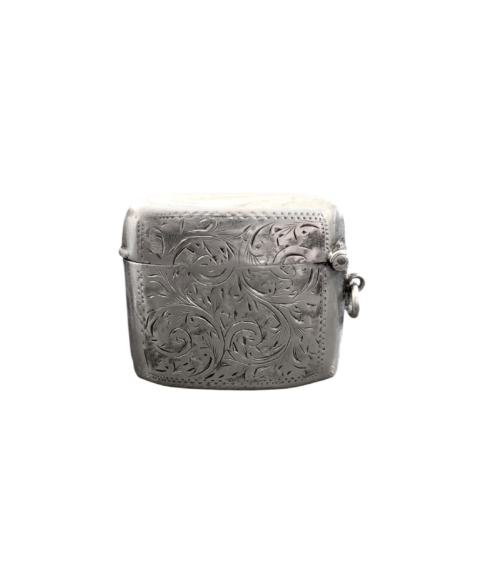 A small rectangular sterling silver vesta case with hand-engraved scrollwork, a central vacant shield cartouche, and a side suspension ring. View II