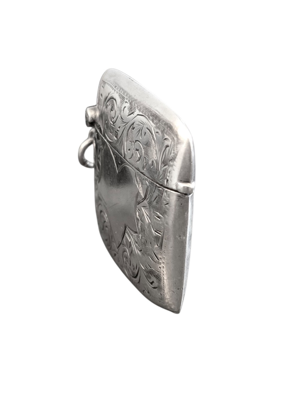 A small rectangular sterling silver vesta case with hand-engraved scrollwork, a central vacant shield cartouche, and a side suspension ring. View III