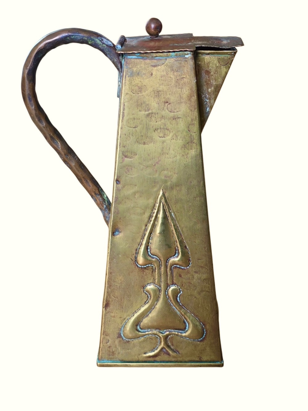 A tapered square brass water jug with a fitted metal lid, curved handle, and embossed stylised Art Nouveau motifs on the sides. View IV
