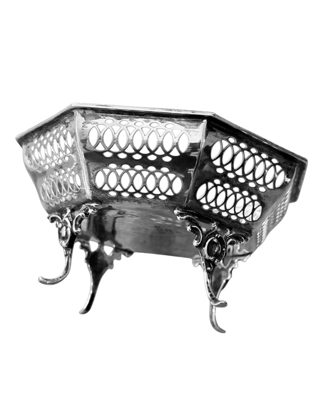 An octagonal sterling silver bonbon dish featuring pierced fretwork sides and three splayed scroll feet. View III
