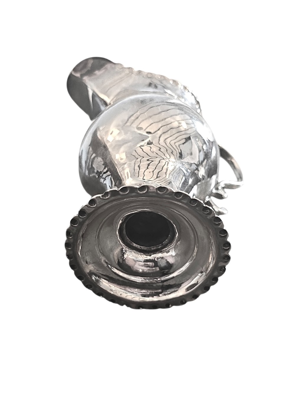 A George III sterling silver cream jug featuring a baluster shape, scalloped rim, double-scroll handle, and pedestal base. View VI