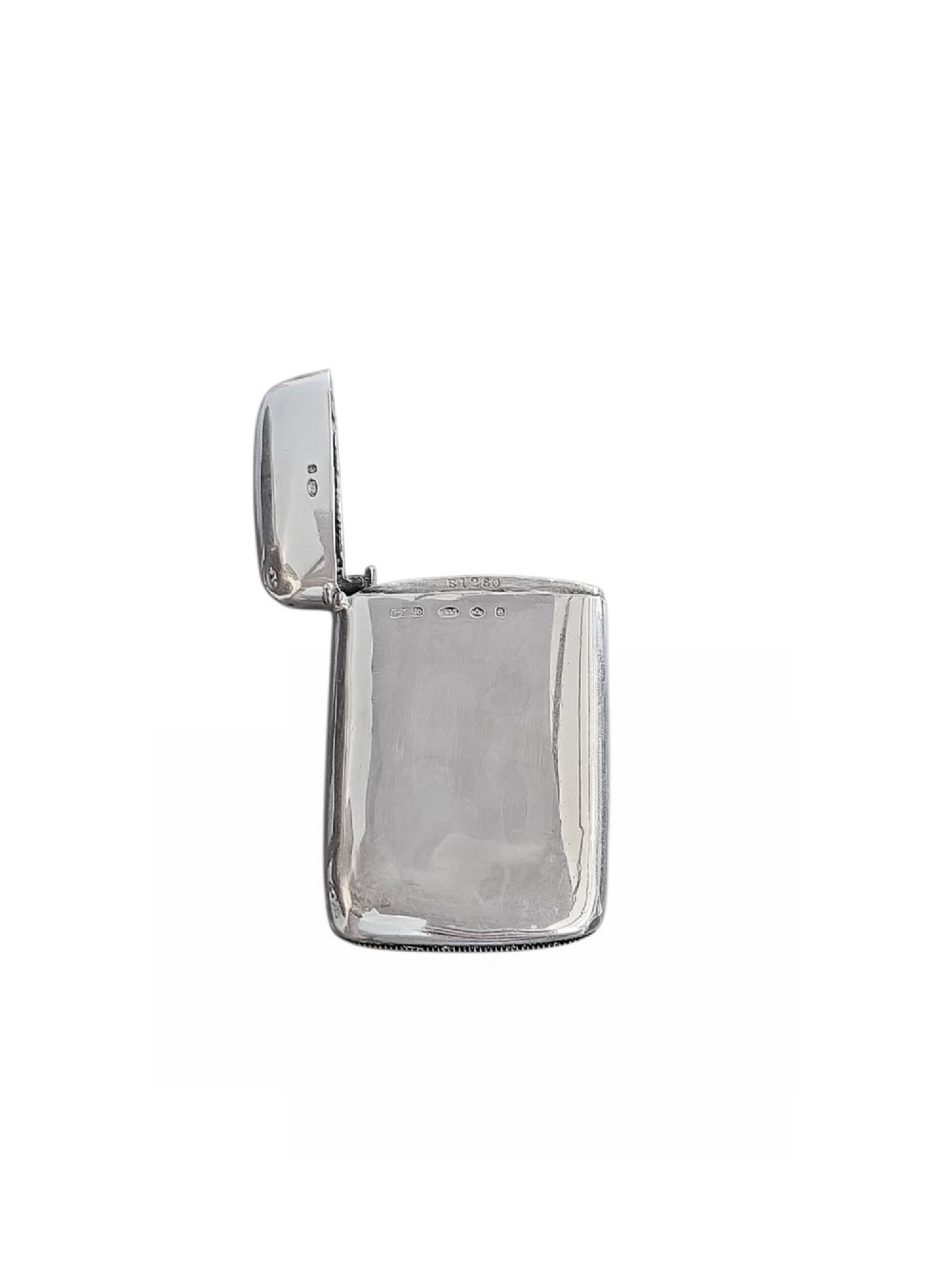 An Edwardian sterling silver vesta case featuring embossed relief detailing of Cupid and Psyche framed by scrollwork borders. View III
