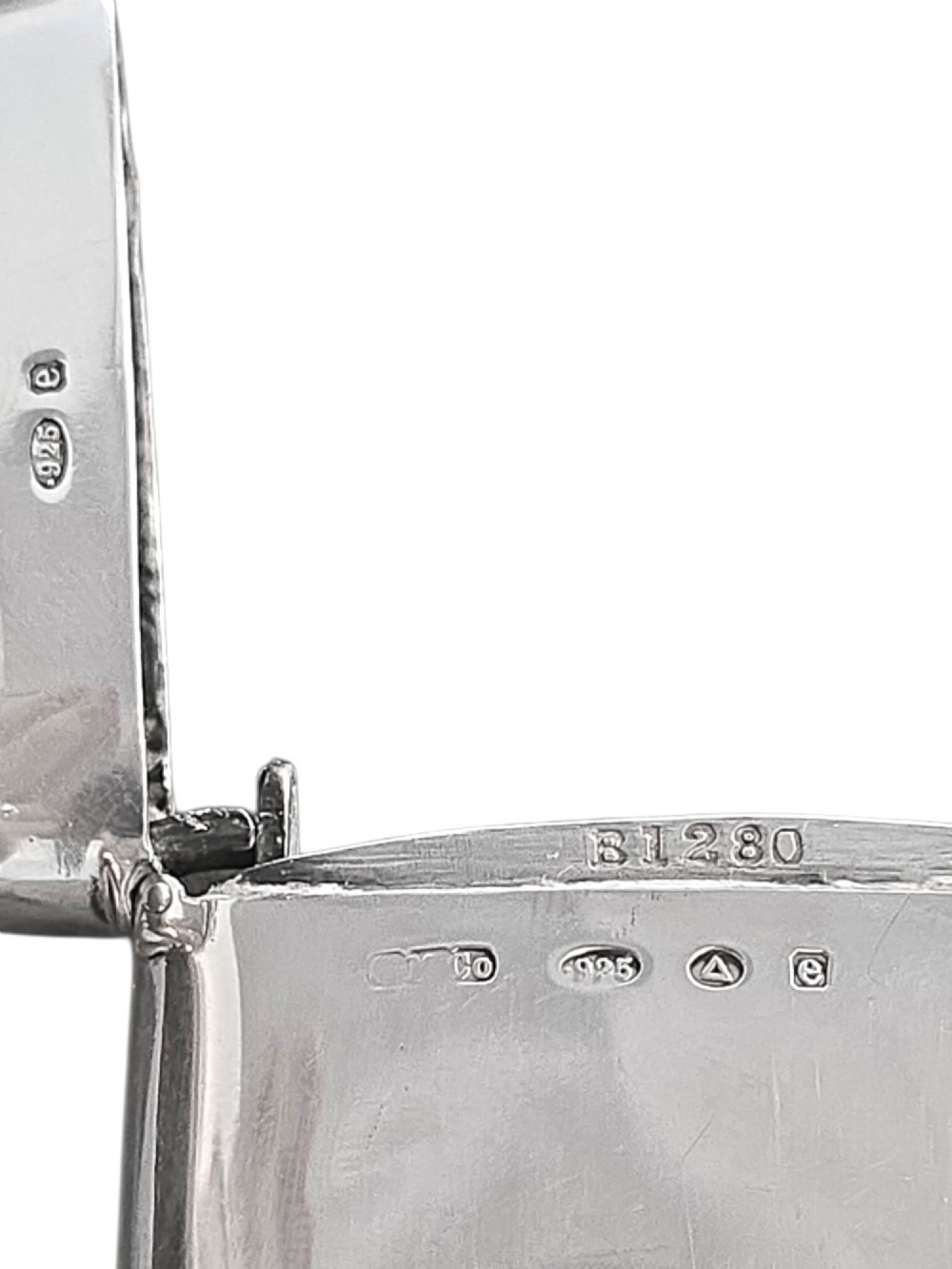 An Edwardian sterling silver vesta case featuring embossed relief detailing of Cupid and Psyche framed by scrollwork borders. View V