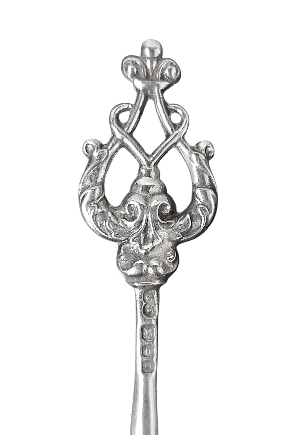 A set of eight sterling silver hors doeuvre skewers arranged in a fan shape, featuring ornate openwork scrollwork handles and tapered pins. View II