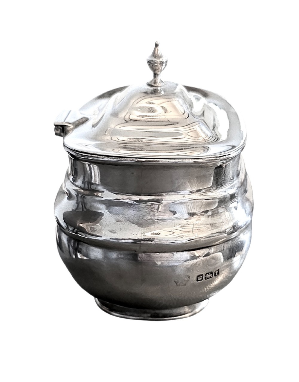 An Edwardian sterling silver tea caddy featuring a bulbous body, stepped lid, and urn-shaped finial. View IV