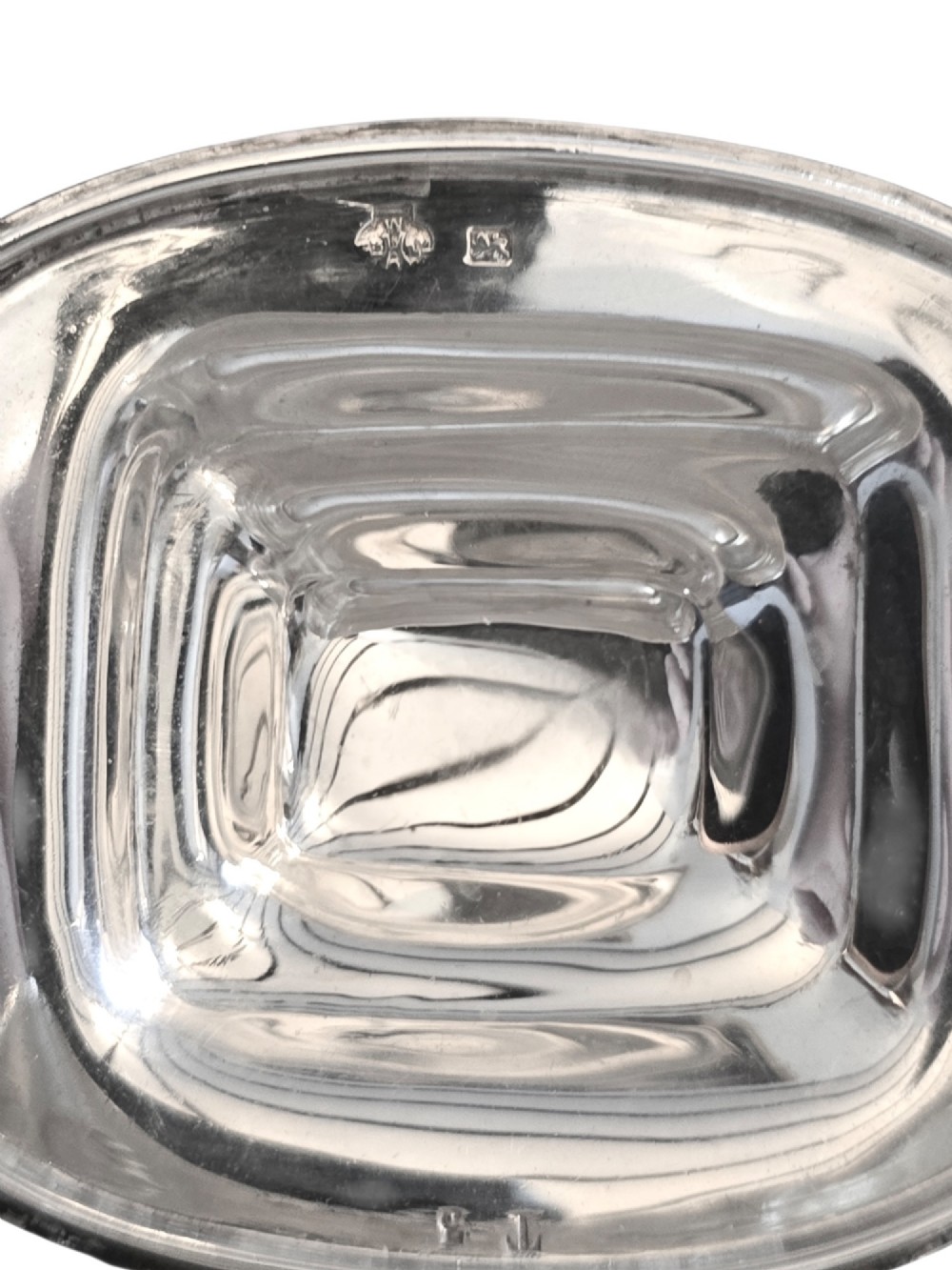 An Edwardian sterling silver tea caddy featuring a bulbous body, stepped lid, and urn-shaped finial. View VI