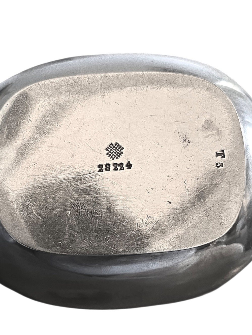 An Edwardian sterling silver tea caddy featuring a bulbous body, stepped lid, and urn-shaped finial. View VII