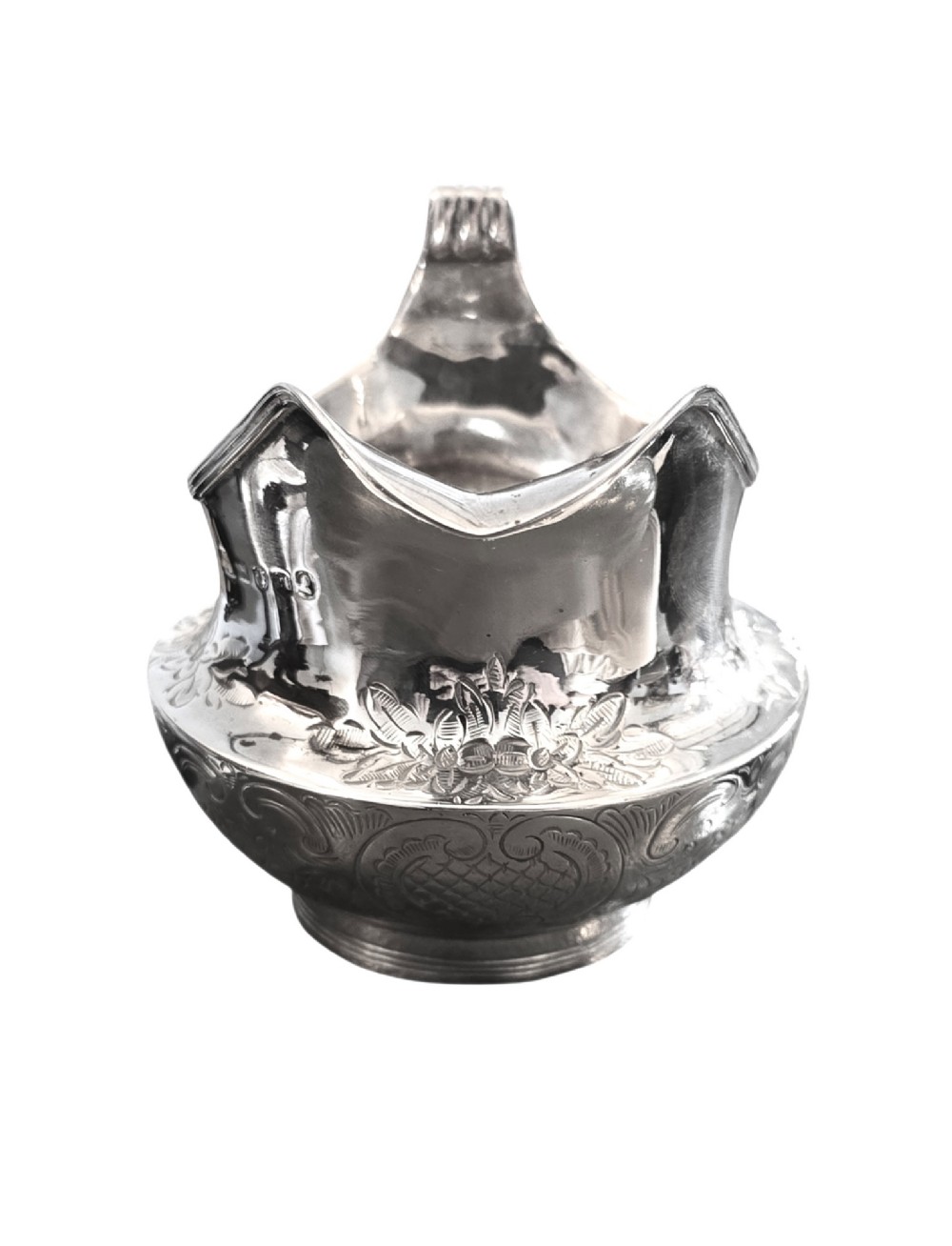 A George III sterling silver cream jug with chased scroll decoration, an angular high loop handle, and a circular foot. View IV