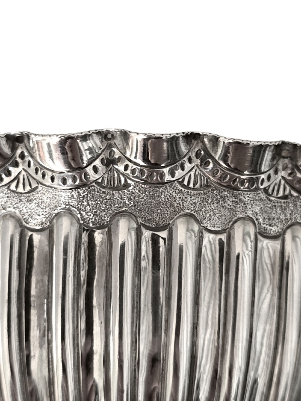 A late Victorian sterling silver sugar bowl with a scalloped rim, reeded fluted lower body, and a gold gilt interior. View III