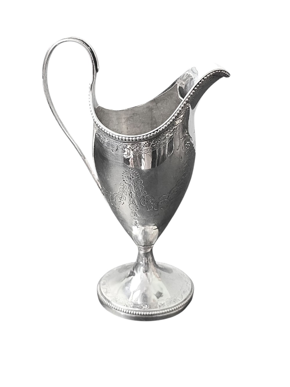 A George III sterling silver helmet-shaped cream jug with bright-cut floral engraving, a beaded rim, a high loop handle, and a circular pedestal foot. View III