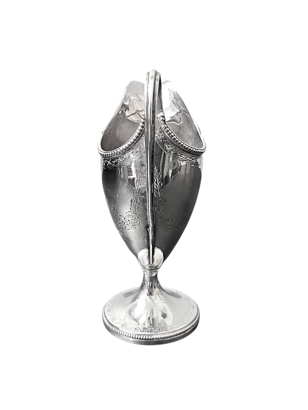 A George III sterling silver helmet-shaped cream jug with bright-cut floral engraving, a beaded rim, a high loop handle, and a circular pedestal foot. View IV