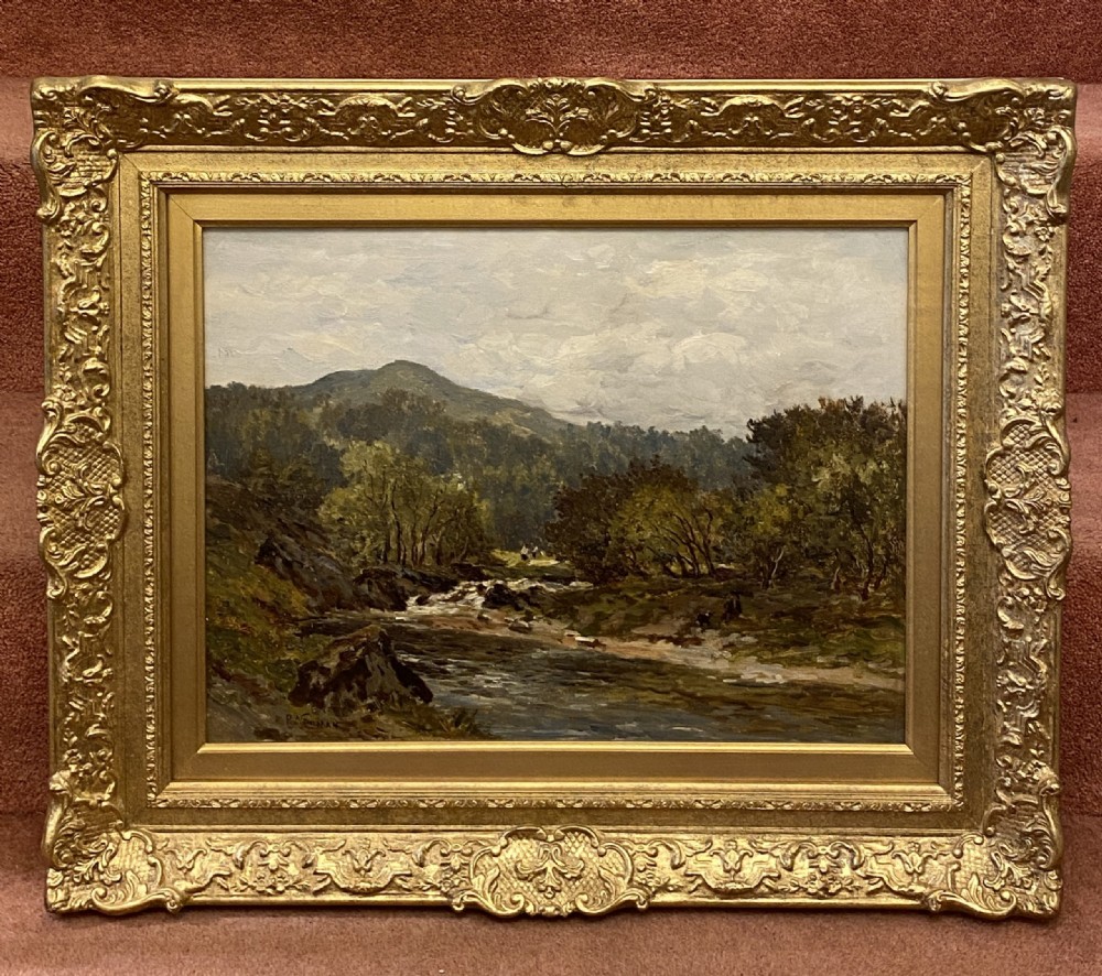 A 19th-century oil painting on canvas depicting a North Wales river and mountain landscape, set within an ornate gilded frame.