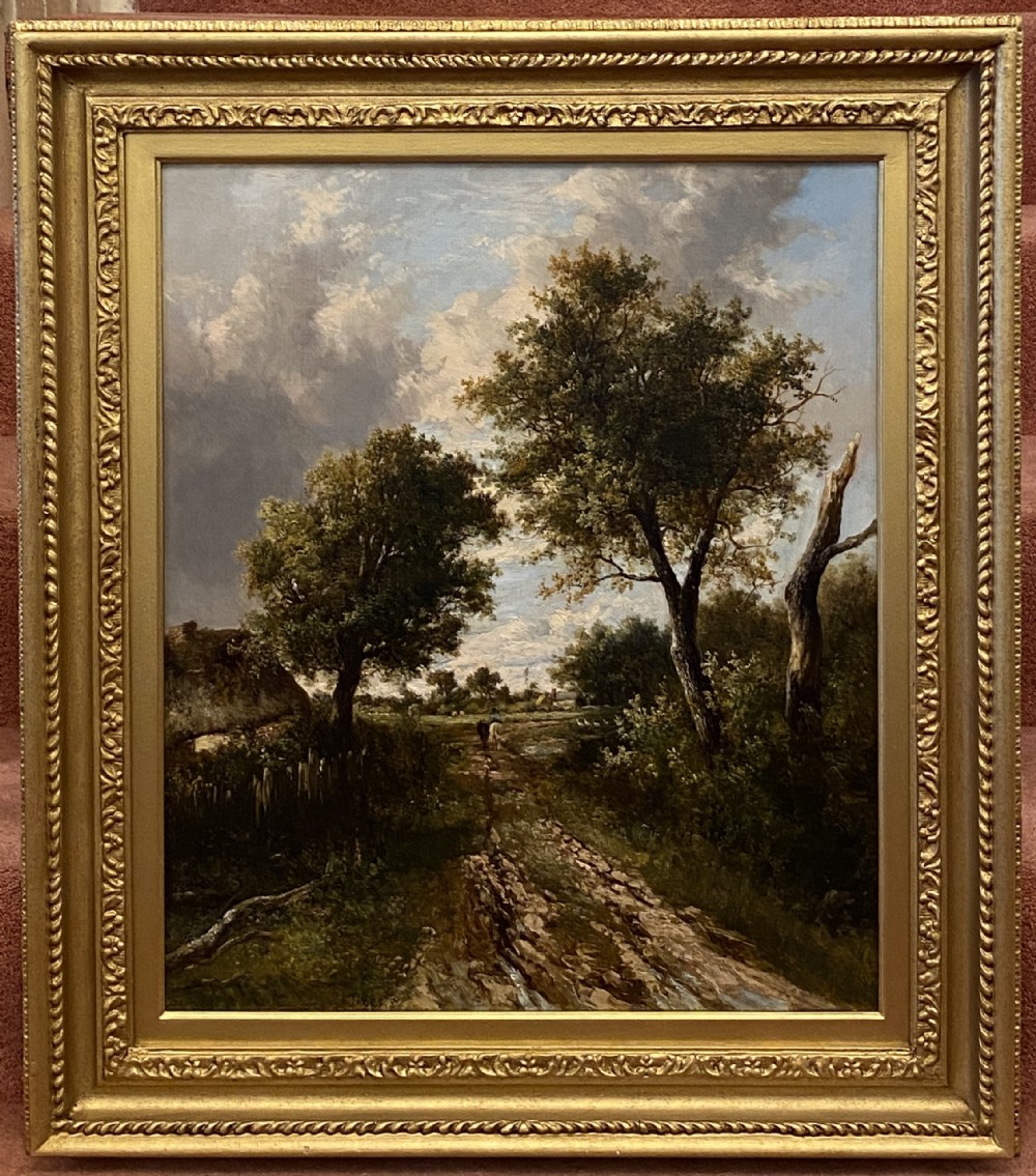A 19th-century oil painting on canvas depicting a rutted dirt track through a wooded landscape, framed in a gilded moulded frame.