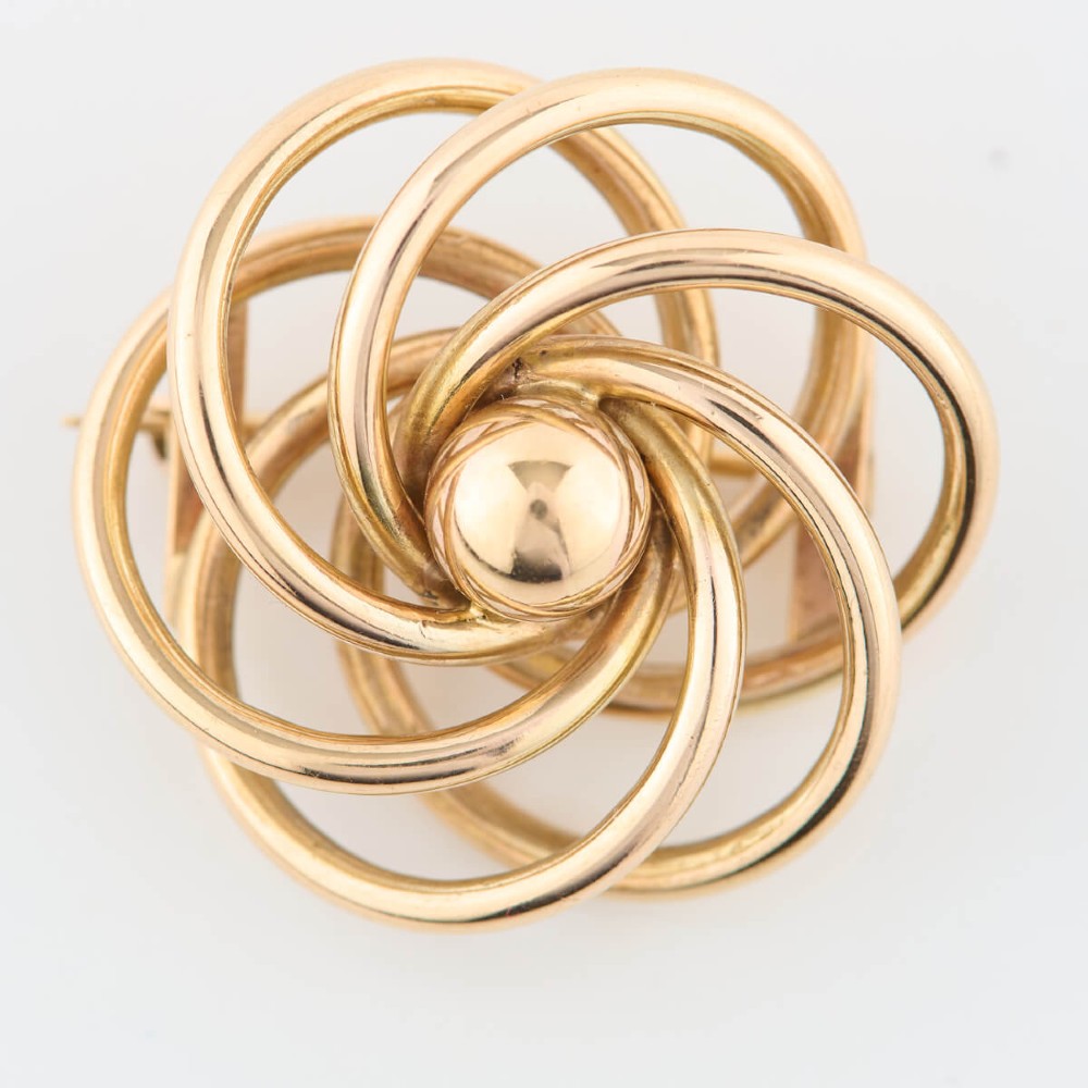 A 1950s 9ct yellow gold brooch featuring a central polished sphere surrounded by concentric swirling wire loops. View III