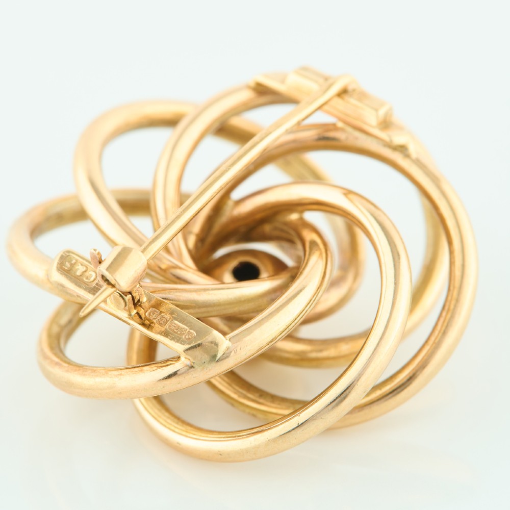A 1950s 9ct yellow gold brooch featuring a central polished sphere surrounded by concentric swirling wire loops. View VI