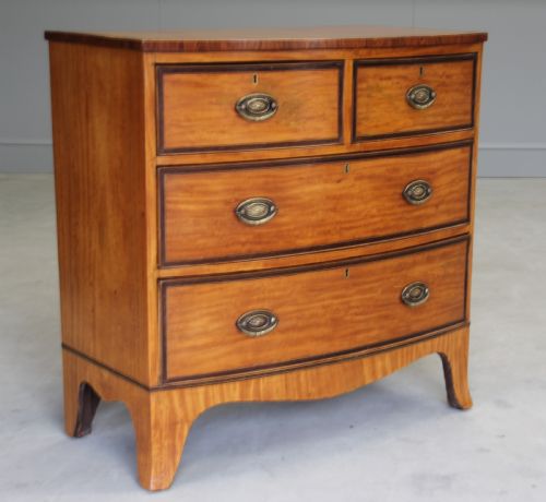 fig 2. An 18th century satinwood chest of drawers.