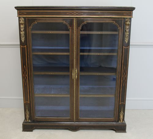 fig 1. A VICTORIAN EBONIZED DISPLAY CABINET