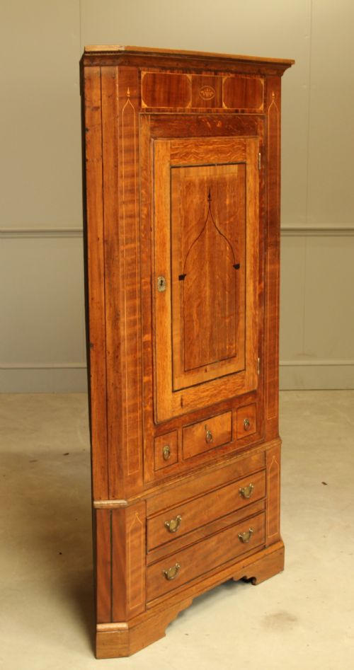 fig 1. A GEORGE III OAK AND MAHOGANY CORNER CABINET.
