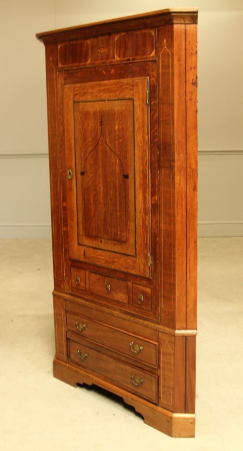 fig 2. A GEORGE III OAK AND MAHOGANY CORNER CABINET.