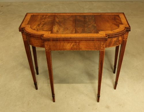 fig 1. A Sheraton period mahogany breakfront card table.