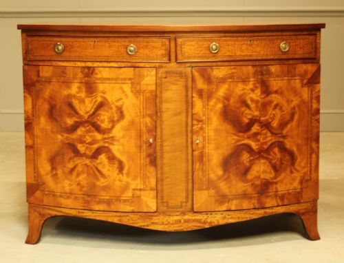 An Edwardian Satinwood Bow Fronted Two Door Sideboard.