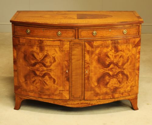 fig 1. AN EDWARDIAN SATINWOOD BOW FRONTED TWO DOOR SIDEBOARD.