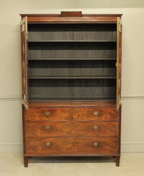 fig 1. A 19TH CENTURY MAHOGANY BOOKCASE DISPLAY ON CHEST.