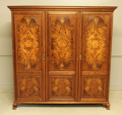 An Early 20th Century Burr Walnut Triple Wardrobe.