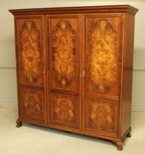 fig 1. AN EARLY 20TH CENTURY BURR WALNUT TRIPLE WARDROBE.