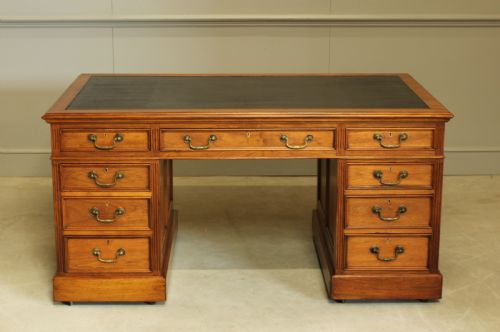 fig 1. An early 20th century walnut twin pedestal writing desk.