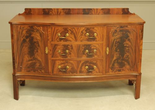 fig 1. An early 20th century curl mahogany serpentine sideboard.