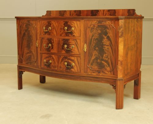 fig 2. An early 20th century curl mahogany serpentine sideboard.