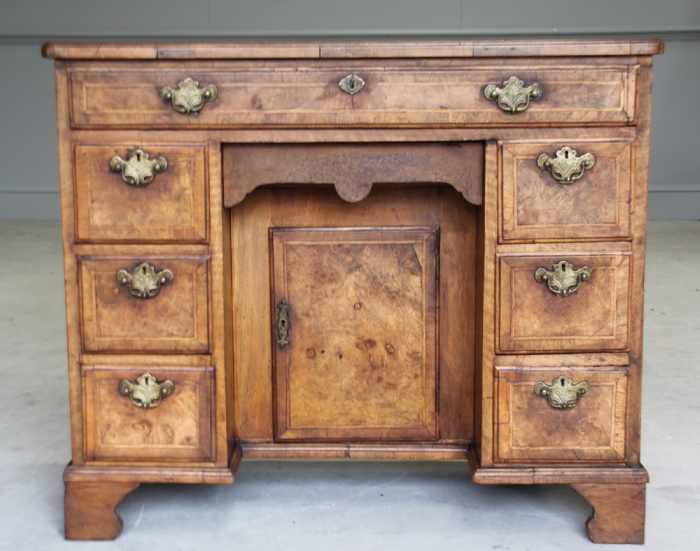 An 18th century burr walnut kneehole desk.