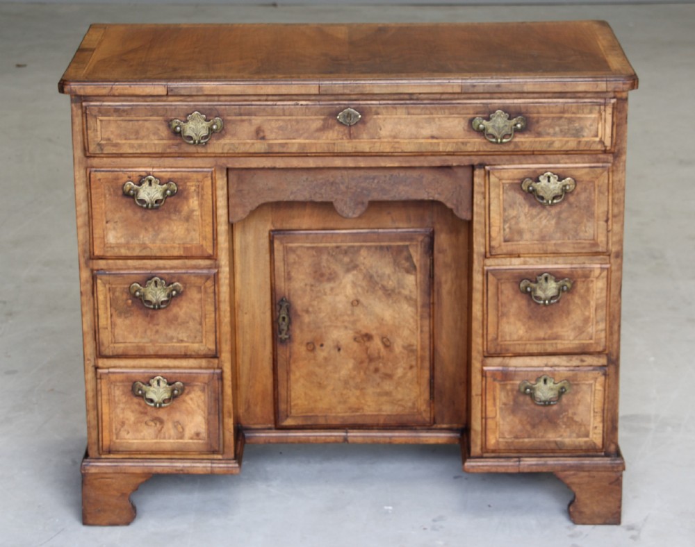 An 18th century burr walnut kneehole desk. View II