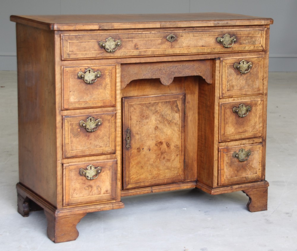 An 18th century burr walnut kneehole desk. View VI