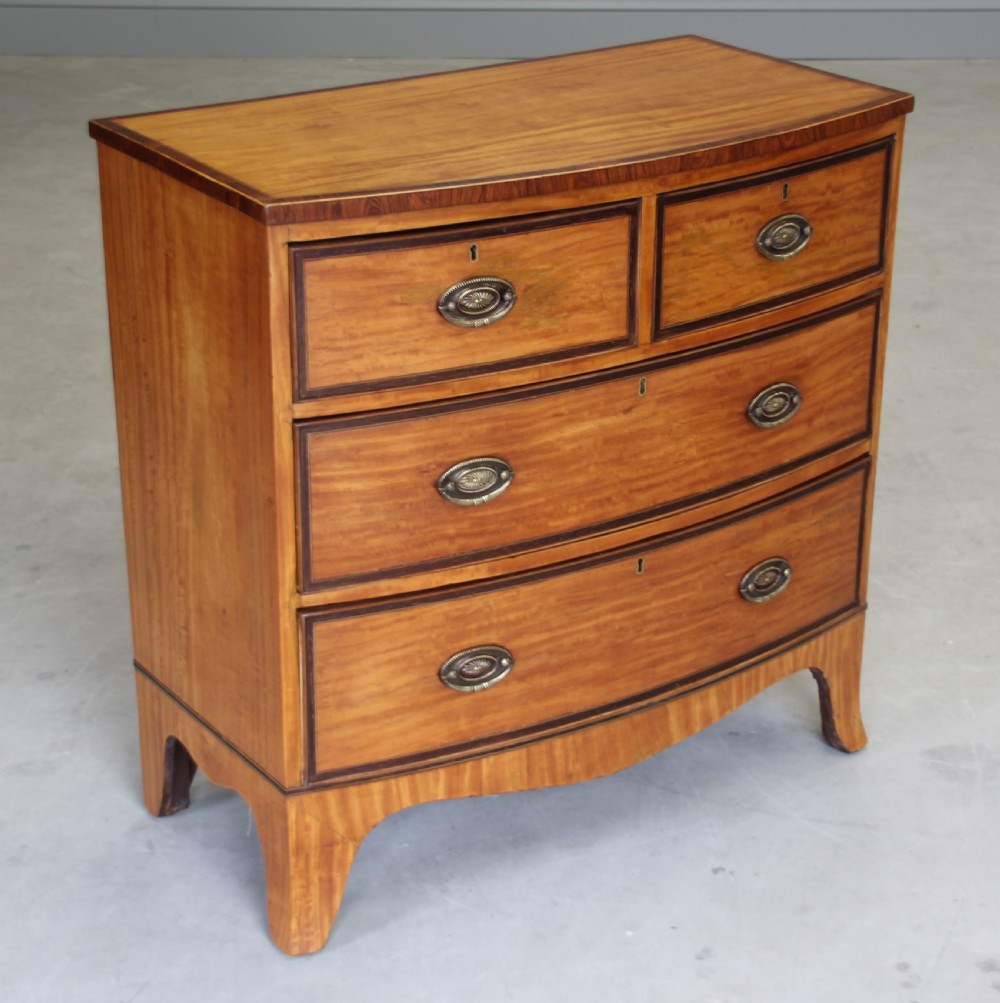 An 18th century satinwood chest of drawers.  View IV