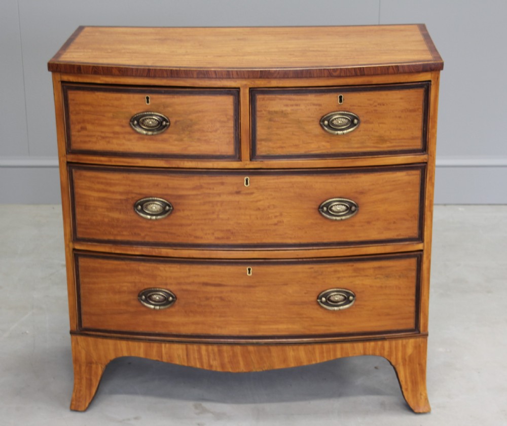 An 18th century satinwood chest of drawers.  View V