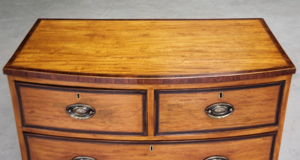 An 18th century satinwood chest of drawers.  View VI
