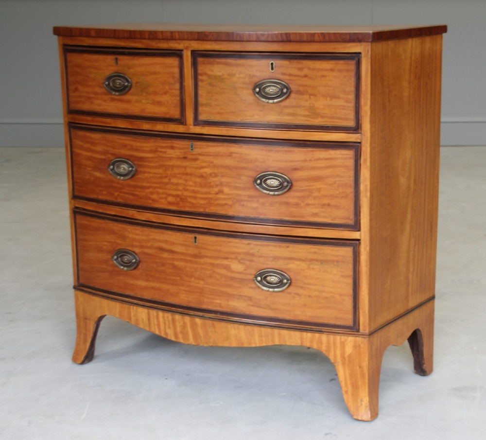 An 18th century satinwood chest of drawers.  View VII
