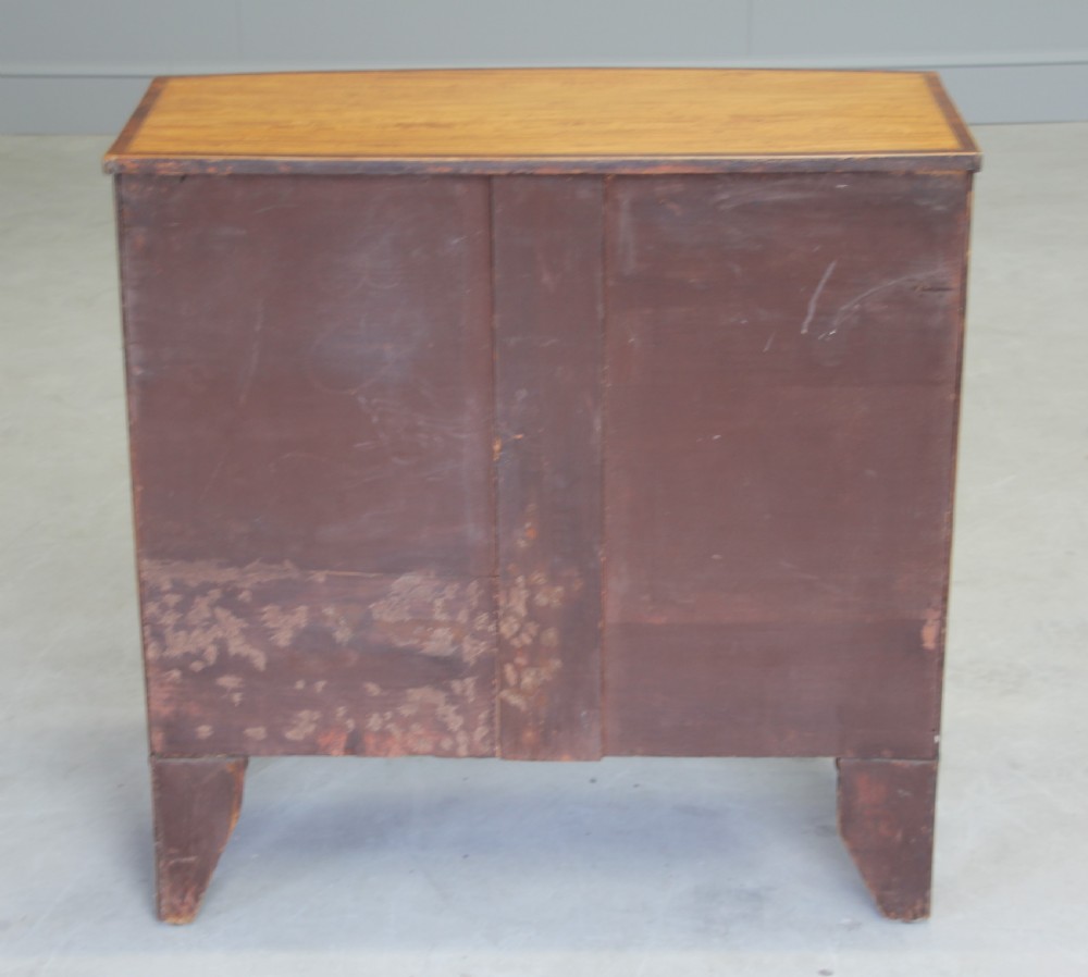 An 18th century satinwood chest of drawers.  View VIII